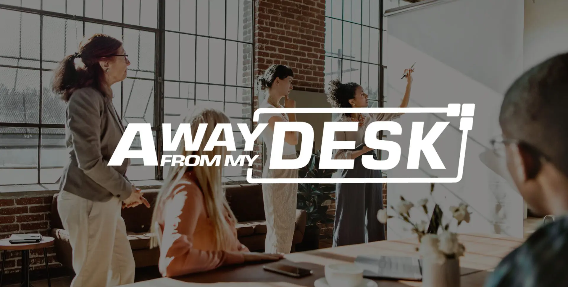A group of women discussing a topic of conversation with the Away From My Desk logo on top of it