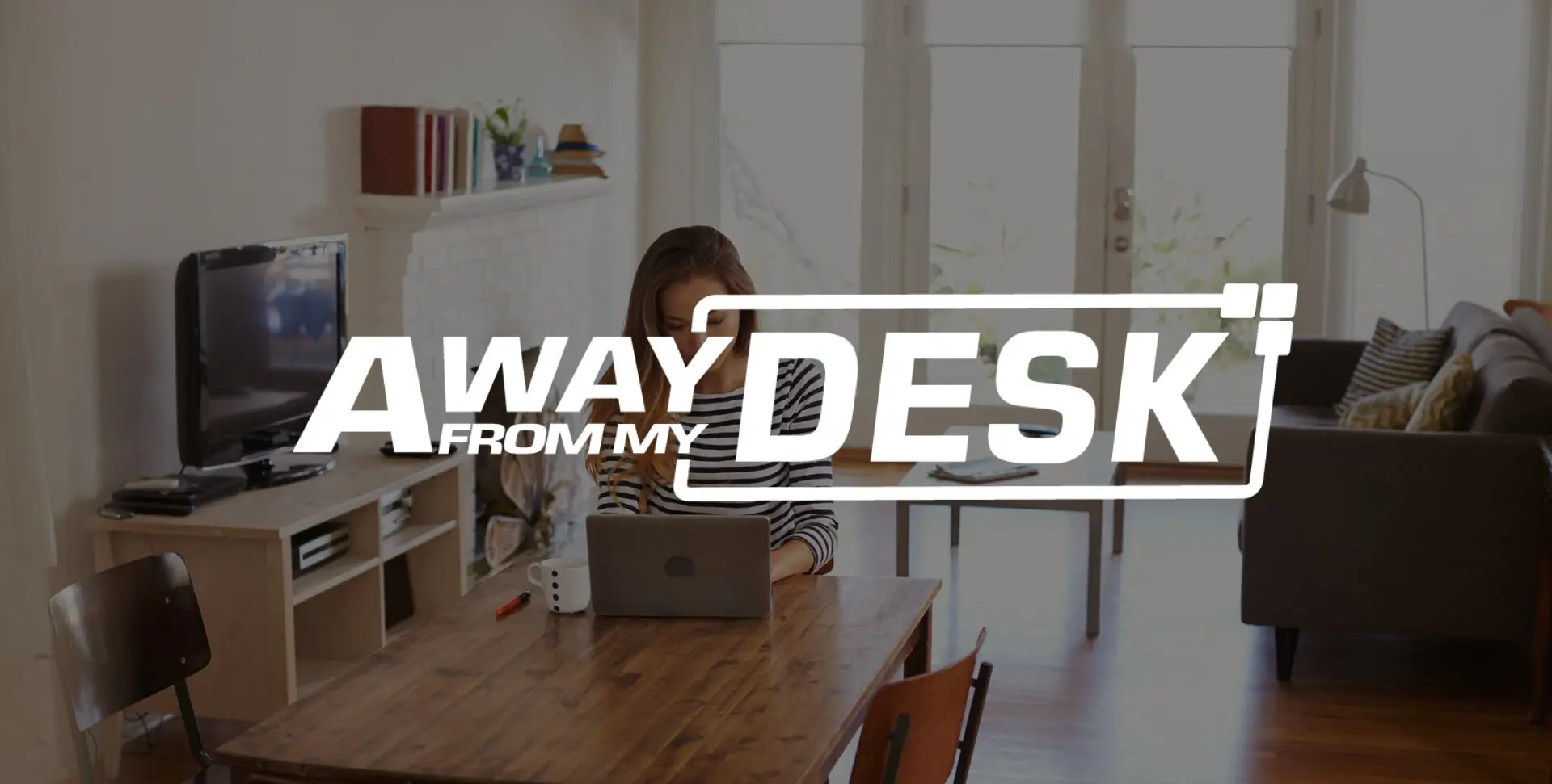 Woman working at her table with the away from my desk logo on top of it