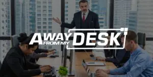 Serious looking businessman wearing a suit holding a meeting with the away from my desk logo on top of it