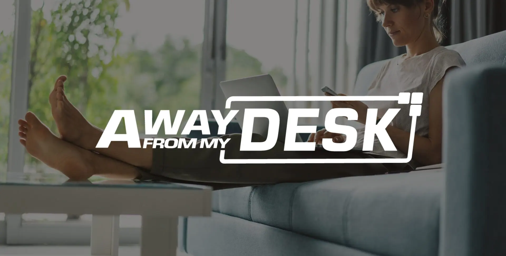 Women with her feet up with her laptop on her lap with the away from my desk logo on top of it