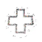 Large group of people stood up together to form the silhouette of a NHS cross, on a white background