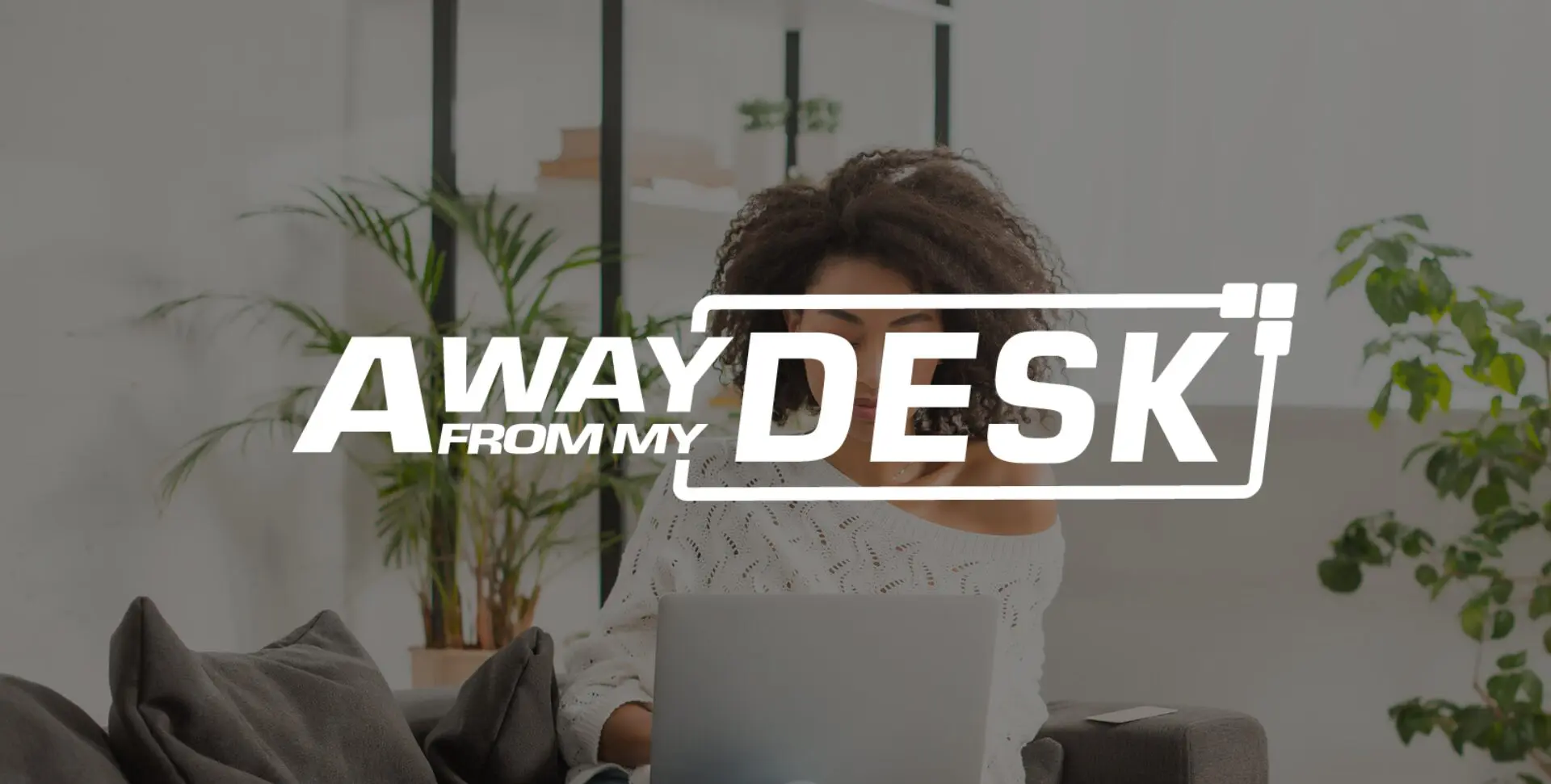 Woman on her laptop with the away from my desk logo on top of it