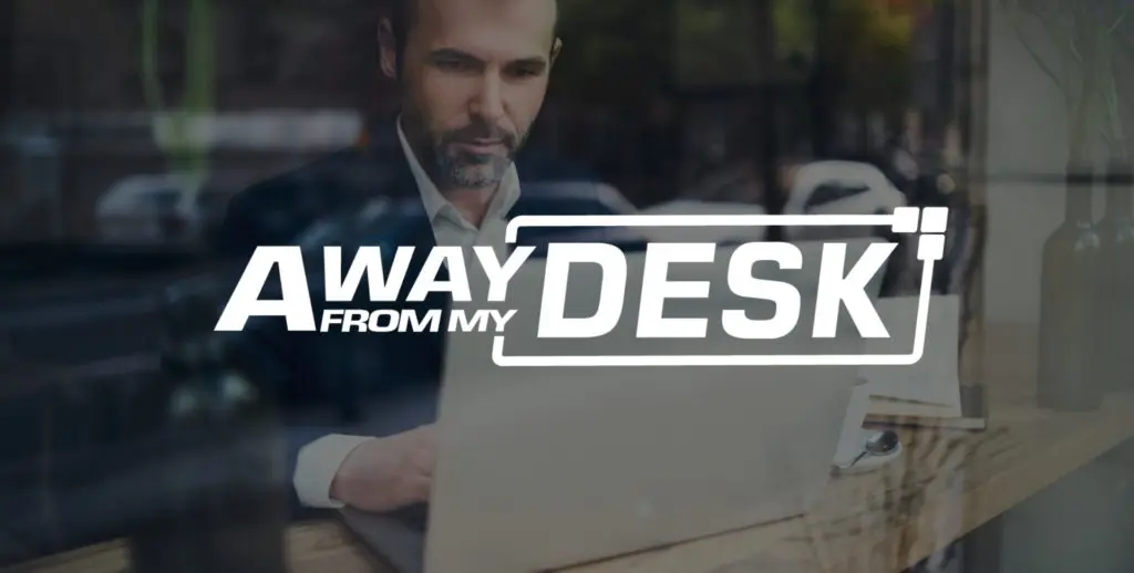 man in a suit looking at his computer with the Away From My Desk logo on top of it
