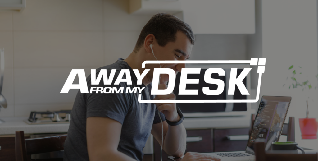 Man working from home on the phone to someone with his headphones in his ears