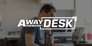 Man working from home on the phone to someone with his headphones in his ears