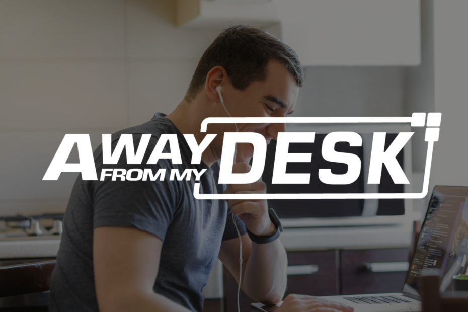 Man working from home on the phone to someone with his headphones in his ears