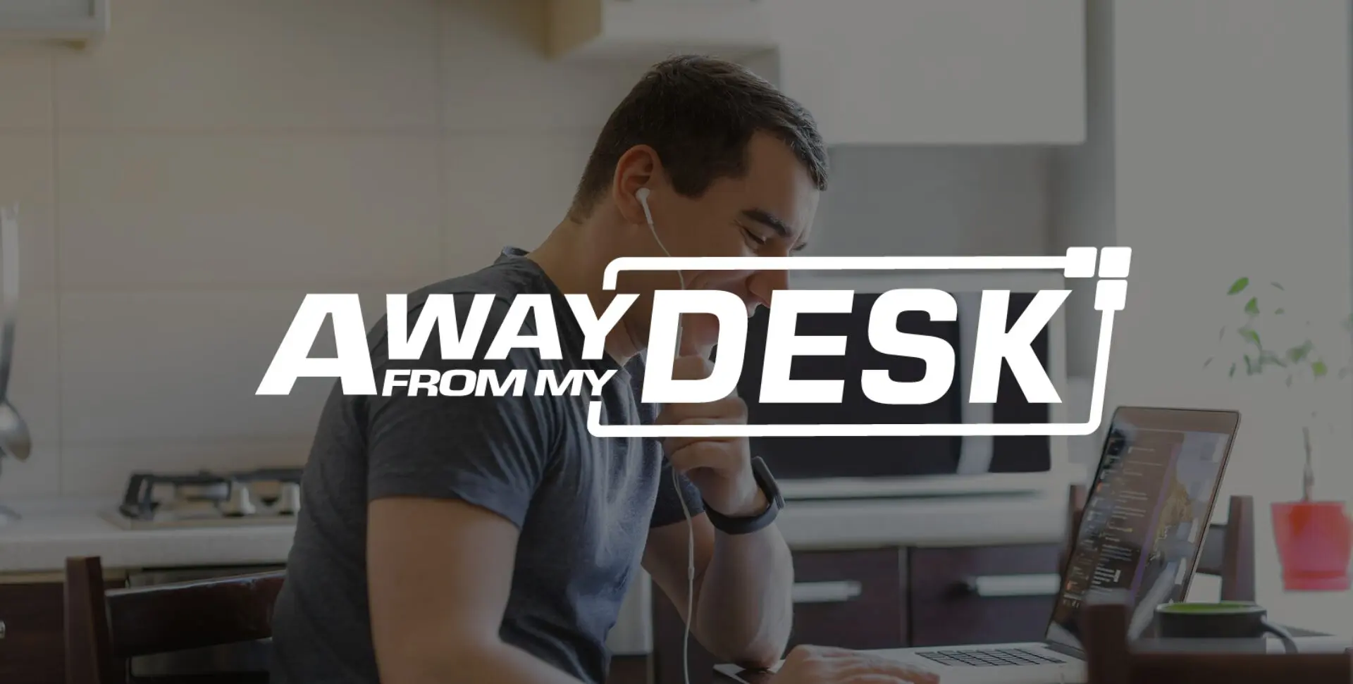 Man working from home on the phone to someone with his headphones in his ears