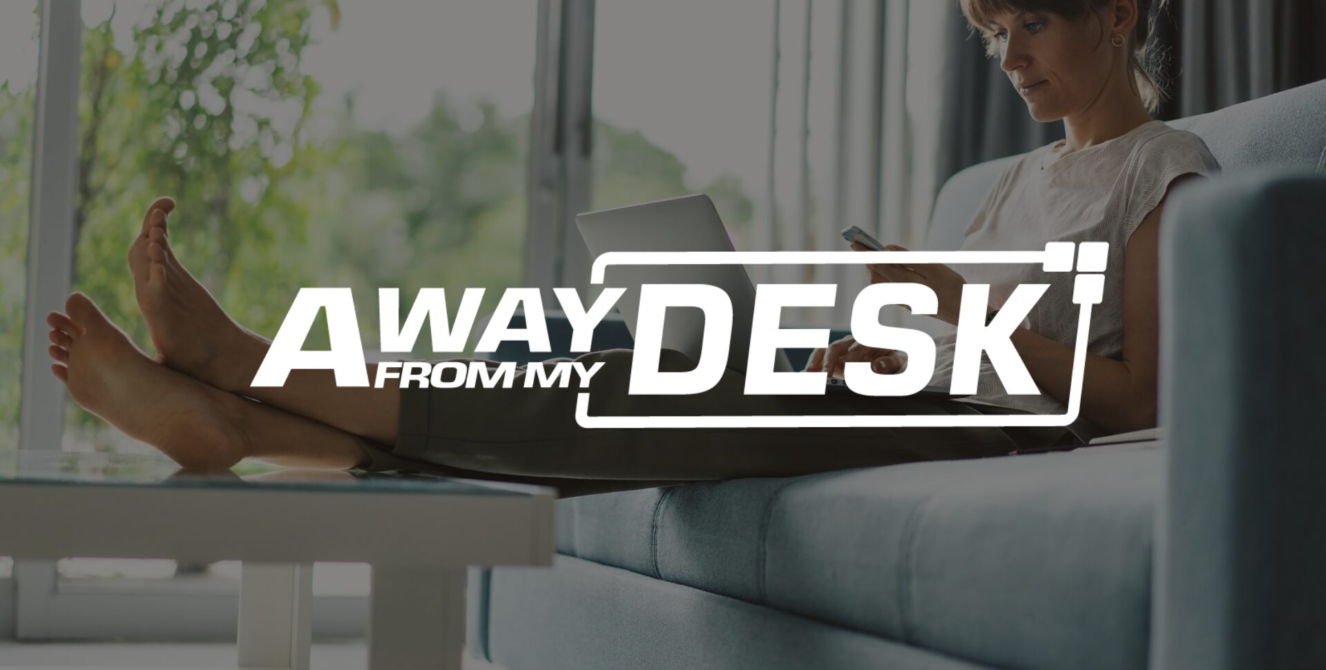 Women with her feet up with her laptop on her lap with the away from my desk logo on top of it