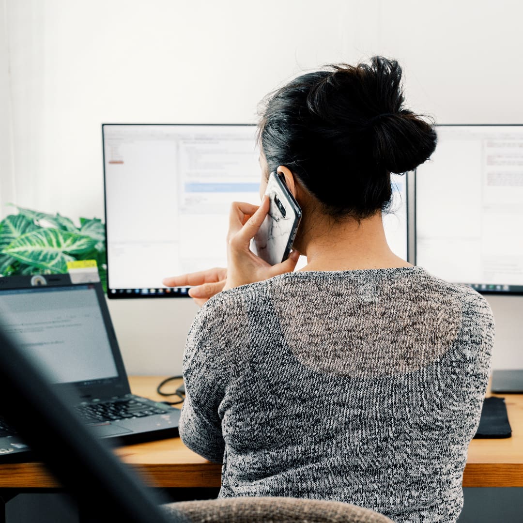 Lady sat at a desk on a Business Call, working remotely