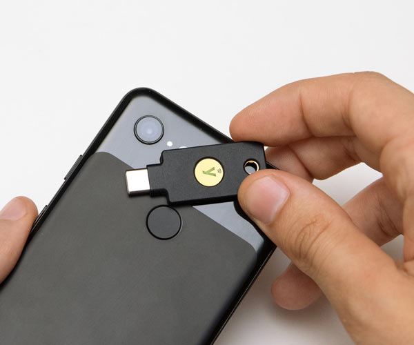 YubiKey 5c nfc token being held over the back of a mobile phone